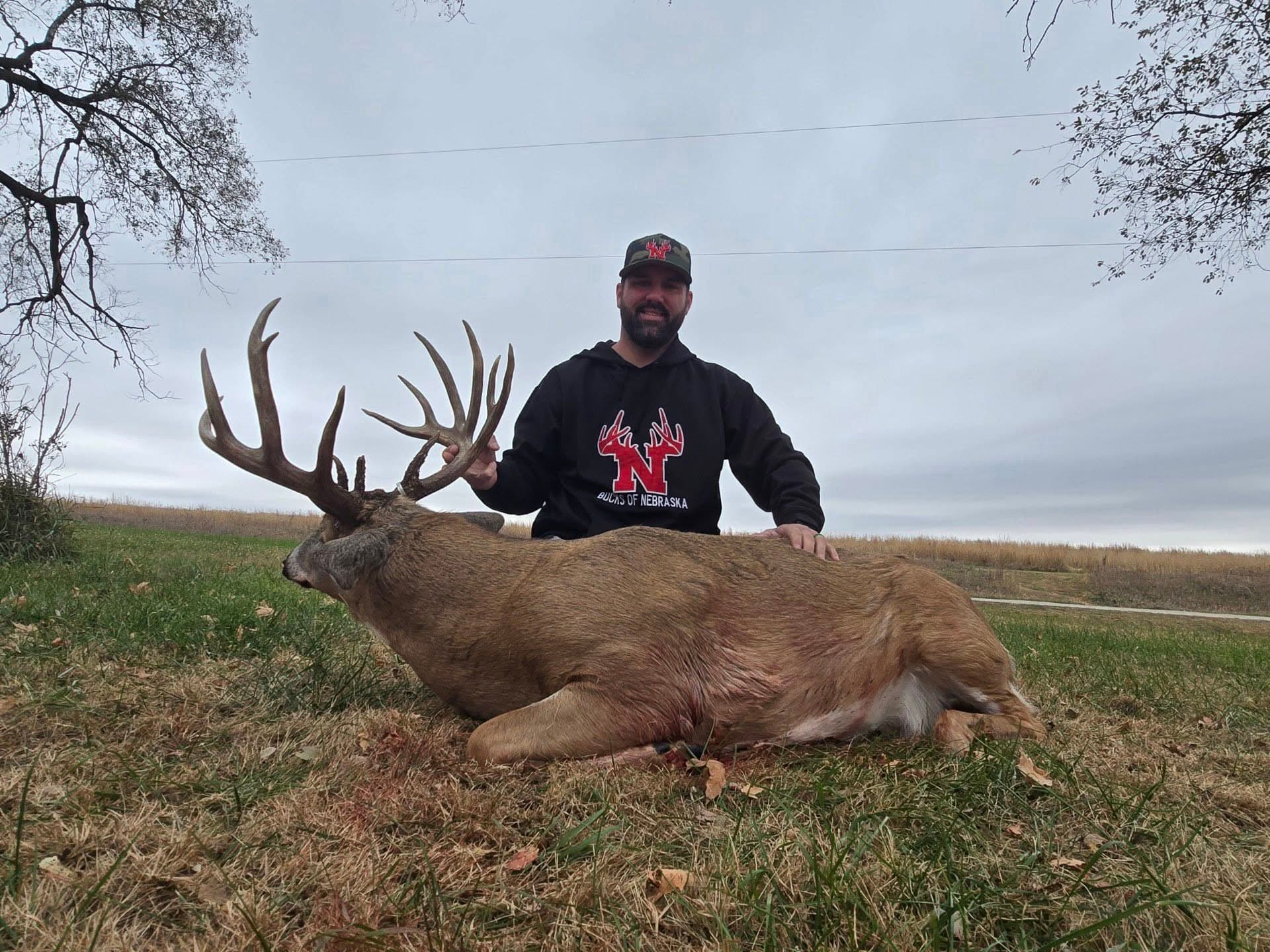 Cody Neer, founder of Bucks of Nebraska, with a whitetail buck
